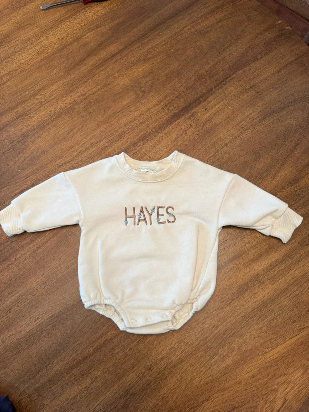 Cream Baby Onesie with 'HAYES' Embroidery